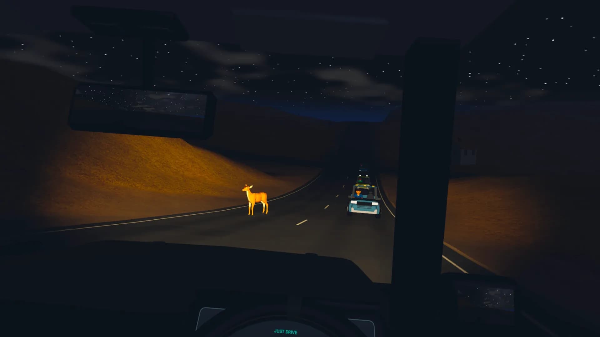 Headlights catching a deer on a winding road at night